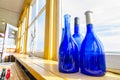 Blue Bottles In A Window Beside The Sea, Newfoundland Canada.