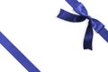 Blue bow satin navy blue ribbon band stripe fabric on corner isolated on white background with clipping path for Christmas Royalty Free Stock Photo