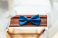 Blue bow tie on a wooden plank. Accessory for formal dress. Symbol of elegance and fashion for men. Royalty Free Stock Photo
