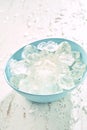 Blue bowl filled with frozen ice cubes Royalty Free Stock Photo