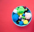 Blue bowl of fluffy ball on red background