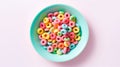 Blue bowl with fruit cereal rings on a light pink background, top view banner