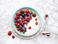 Blue bowl of hot oatmeal breakfast cereal with fresh berries, strawberries, cherries and blueberries from above Royalty Free Stock Photo