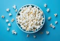 Blue bowl with popcorn on blue background. Crispy classic popcorn snack Royalty Free Stock Photo