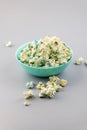 Blue bowl with sweet popcorn, isolated on a gray background Royalty Free Stock Photo