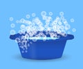 Blue bowl with water and soap suds, laundry, cleaning and hygiene