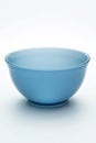 A blue bowl on a white table, suitable for kitchen or dining room decor Royalty Free Stock Photo