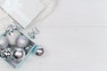 Blue box with silver Christmas balls on the white background, mock up, copy space Royalty Free Stock Photo