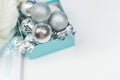 Blue box with silver Christmas balls on the white background, mock up, copy space Royalty Free Stock Photo