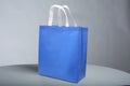 Blue Box Type Bag with white handle, PP Non Woven Fabric Shopping Bag on table