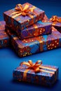 Blue boxes, gifts with red decorations, orange ribbons on a navy blue background. Gifts as a day symbol of present and Royalty Free Stock Photo