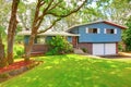 Blue brick American rambler exterior with nice front garden. Royalty Free Stock Photo