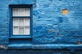 A blue brick building featuring a window with a broken pane of glass Royalty Free Stock Photo