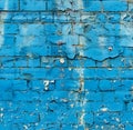 A blue brick wall with chipped paint,