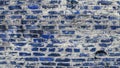 Blue brick wall with cracks of rural building