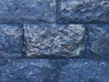 Blue brick wall. A large brick. Blue cold background with horizontal brickwork.