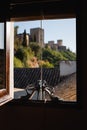 Blue bridal shoes at the window with the view of the Alhambra