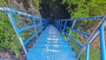 Blue bridge for adventures in a dark cave. For tourists like excitement