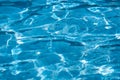 Blue and bright ripple water surface in swimming pool with sun r Royalty Free Stock Photo