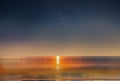 Blue bright starry sky on pink yellow sunset at sea water vawe reflection blurred light full moon moonlight  skyline  nebula natur Royalty Free Stock Photo