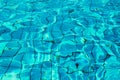 Blue and bright water in a swimming pool with sun reflection Royalty Free Stock Photo