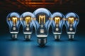 Blue brilliance Energy saving lamp flanked by incandescent bulbs in row Royalty Free Stock Photo