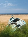 Blue abandoned wooden boat out of sea. Royalty Free Stock Photo