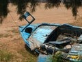 Blue abandoned wooden boat out of sea. Royalty Free Stock Photo