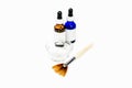 Blue and brown eye dropper bottles for cosmetic chemical peel formula, with dish and applicator makeup brush, for beauty treatmen