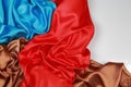 Blue and brown and red silk satin cloth of wavy folds texture ba Royalty Free Stock Photo