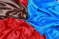 Blue and brown and red silk satin cloth of wavy folds texture ba Royalty Free Stock Photo