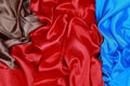 Blue and brown and red silk satin cloth of wavy folds texture ba Royalty Free Stock Photo