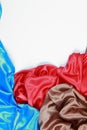 Blue and brown and red silk satin cloth of wavy folds texture ba Royalty Free Stock Photo