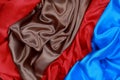 Blue and brown and red silk satin cloth of wavy folds texture ba Royalty Free Stock Photo