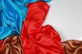 Blue and brown and red silk satin cloth of wavy folds texture ba Royalty Free Stock Photo