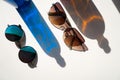 Blue and brown sunglasses with glass bottle reflections Royalty Free Stock Photo