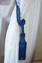 Blue brush wings on a white lace curtain. The ease and tenderness Royalty Free Stock Photo