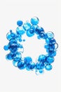 Blue bubbles forming a circle on a white background. Suitable for abstract concepts or design elements Royalty Free Stock Photo