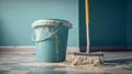 Blue bucket with mop against blue wall. Soap suds, floor cloth and brush for cleanliness and order, copy space