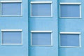 Blue Building Facade with Six Closed Windows Shutters Royalty Free Stock Photo