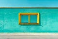 A blue building with a yellow window on the side of it. Generative AI Royalty Free Stock Photo