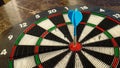 Blue bullseye dart arrow hitting target center of dartboard. Goal target to success concept Royalty Free Stock Photo