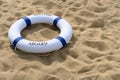 Blue buoy on sand with word of welcome aboard Royalty Free Stock Photo