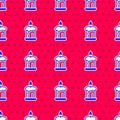 Blue Burning candle in candlestick icon isolated seamless pattern on red background. Old fashioned lit candle Royalty Free Stock Photo