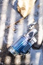 The blue burning lighter is placed on an old and wet cement background, indicating that even if there is water, Royalty Free Stock Photo