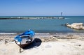 Blue burnt boat on the seashore Bari, Italy