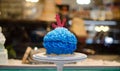 Blue buttercream cake with red anchor in front of cake-store Royalty Free Stock Photo