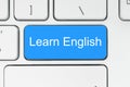 Blue button with learn english words on the keyboard