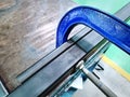 Blue C-Clamp Holding Metal Profile Frames Together at Workshop