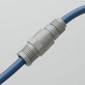 A blue cable is connected with a gray plastic coupling. The connector features Royalty Free Stock Photo